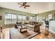 Bright living room with large windows, comfortable seating, and hardwood floors at 16399 Somerset Dr, Broomfield, CO 80023