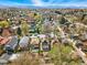 Stunning aerial view of a residential neighborhood with tree-lined streets and mountain views in the distance at 2772 Julian St, Denver, CO 80211