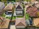 Aerial view of home with a fenced backyard, deck, mature trees, and detached garage at 2772 Julian St, Denver, CO 80211