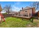 Spacious backyard showing a large wood deck with black railings and lush green lawn at 2772 Julian St, Denver, CO 80211