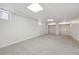 Spacious carpeted basement is illuminated by windows and recessed lights, offering ample space for various activities at 2772 Julian St, Denver, CO 80211