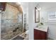 The bathroom features a tiled walk-in shower, a vanity with cherry cabinet, and modern fixtures at 2772 Julian St, Denver, CO 80211