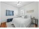 A bright, well-lit bedroom featuring a comfortable bed, modern décor, and hardwood flooring at 2772 Julian St, Denver, CO 80211