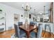 Cozy dining area with hardwood floors and seamless flow to the updated kitchen, perfect for Gathering meals and entertaining at 2772 Julian St, Denver, CO 80211