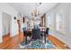 Elegant dining room with hardwood floors, stylish lighting, and a seamless transition to the adjacent kitchen area at 2772 Julian St, Denver, CO 80211