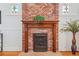Close-up of a unique brick fireplace with a wood mantel, adding character and warmth to the living space at 2772 Julian St, Denver, CO 80211