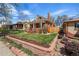 Charming brick home with a well-manicured lawn and lovely landscaping at 2772 Julian St, Denver, CO 80211
