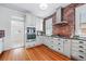 The kitchen features light cabinets, granite countertops, stainless appliances, and brick accent wall at 2772 Julian St, Denver, CO 80211
