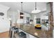 A view of the kitchen featuring stainless appliances, granite counters, bar seating and adjacent spaces at 2772 Julian St, Denver, CO 80211