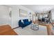 Bright and airy living room featuring hardwood floors, stylish furnishings, and a seamless flow to the dining area at 2772 Julian St, Denver, CO 80211