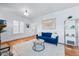 Comfortable living room with large windows, showcasing hardwood floors, contemporary decor, and abundant natural light at 2772 Julian St, Denver, CO 80211