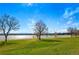 Scenic view of a park and lake with lush green grass and mature trees at 2772 Julian St, Denver, CO 80211
