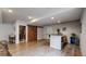 Spacious basement with a wet bar, an interesting wooden barn door, and vinyl plank flooring at 3885 Sandoval St, Brighton, CO 80601