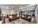 Finished basement featuring two leather couches, modern lighting, and an elegant area rug at 3885 Sandoval St, Brighton, CO 80601