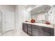 Spacious bathroom with double sinks, modern fixtures, a large mirror, and good lighting at 3885 Sandoval St, Brighton, CO 80601