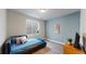 Basement bedroom featuring a comfortable bed, an egress window and modern decor at 3885 Sandoval St, Brighton, CO 80601