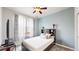 Cozy bedroom with a comfortable bed, a ceiling fan, and a large window at 3885 Sandoval St, Brighton, CO 80601