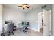Bright bedroom featuring a ceiling fan, neutral carpeting, and equipped with an office desk at 3885 Sandoval St, Brighton, CO 80601