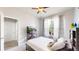 Bright bedroom featuring a ceiling fan, a window with sheer curtains, and a cozy bed with pillows at 3885 Sandoval St, Brighton, CO 80601