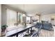 Bright dining area with a large window, wood floors, and stylish furnishings at 3885 Sandoval St, Brighton, CO 80601