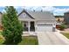 Inviting single-Gathering home with a two-car garage, a covered front porch, and a beautifully landscaped yard at 3885 Sandoval St, Brighton, CO 80601