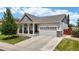 Charming single-Gathering home boasts a well-maintained lawn, attached two-car garage, and inviting front porch at 3885 Sandoval St, Brighton, CO 80601