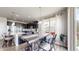 Eat-in kitchen features dark cabinetry, stainless steel appliances, granite countertops, and wood floors at 3885 Sandoval St, Brighton, CO 80601