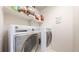Laundry room featuring a side-by-side washer and dryer and shelving for supplies at 3885 Sandoval St, Brighton, CO 80601