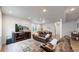 Cozy living room with a comfortable leather sofa, a patterned rug, and a flat-screen TV at 3885 Sandoval St, Brighton, CO 80601