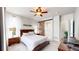 Charming main bedroom featuring a ceiling fan, soft carpeting, a comfortable bed and a sliding barn door at 3885 Sandoval St, Brighton, CO 80601