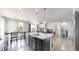 Open concept living space with a kitchen island, dining area, and comfortable living room at 3885 Sandoval St, Brighton, CO 80601
