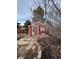 Exterior view of a small shed with a wooden door, stone path, and surrounding foliage at 21041 E Ida Ave, Centennial, CO 80015