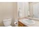 Half bath features a pedestal sink, a mirror, a toilet, and a towel rack at 6052 Jay St, Arvada, CO 80003