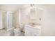 Bright bathroom featuring a shower, toilet, and vanity with sink and storage at 6052 Jay St, Arvada, CO 80003