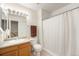 Clean bathroom featuring a vanity, toilet, and a shower with a curtain at 6052 Jay St, Arvada, CO 80003