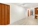 Finished basement hallway showcasing hardwood-style flooring and neutral walls at 6052 Jay St, Arvada, CO 80003