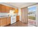 Compact kitchen design featuring a sliding door to the backyard, and wooden cabinets at 6052 Jay St, Arvada, CO 80003