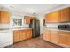 A functional kitchen offering wood cabinetry, a stainless steel refrigerator, and resilient flooring at 6052 Jay St, Arvada, CO 80003