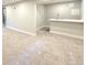 Partially finished basement area featuring carpeted flooring, bar, and neutral paint at 3578 Ivanhoe St, Denver, CO 80207
