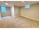 Unfurnished basement area featuring carpeted flooring, and neutral paint at 3578 Ivanhoe St, Denver, CO 80207