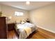 Cozy bedroom featuring hardwood floors, neutral paint, and comfortable bed at 3578 Ivanhoe St, Denver, CO 80207