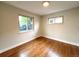 Empty bedroom featuring hardwood floors, neutral paint, and two windows at 3578 Ivanhoe St, Denver, CO 80207