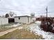A detached one car garage in the backyard with a partial view of the yard at 3578 Ivanhoe St, Denver, CO 80207
