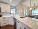 Modern kitchen with stainless steel appliances, bright white cabinets, and quartz countertops at 3578 Ivanhoe St, Denver, CO 80207