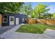 This backyard features a well-maintained lawn, a walkway and a private fence at 734 N Downing St, Denver, CO 80218