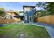 This backyard is spacious, with a covered patio, lush lawn and modern exterior at 734 N Downing St, Denver, CO 80218
