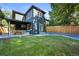 Spacious backyard with a covered patio, lush lawn and modern exterior at 734 N Downing St, Denver, CO 80218
