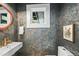 Stylish powder room featuring designer wallpaper, modern fixtures, and elegant decor at 734 N Downing St, Denver, CO 80218