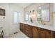 Elegant bathroom featuring a dual sink vanity, decorative lighting, and a neutral tile pattern, offering a luxurious feel at 734 N Downing St, Denver, CO 80218