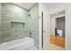 Modern bathroom with light blue tiling, a tub and shower, and a convenient inset shelf at 734 N Downing St, Denver, CO 80218